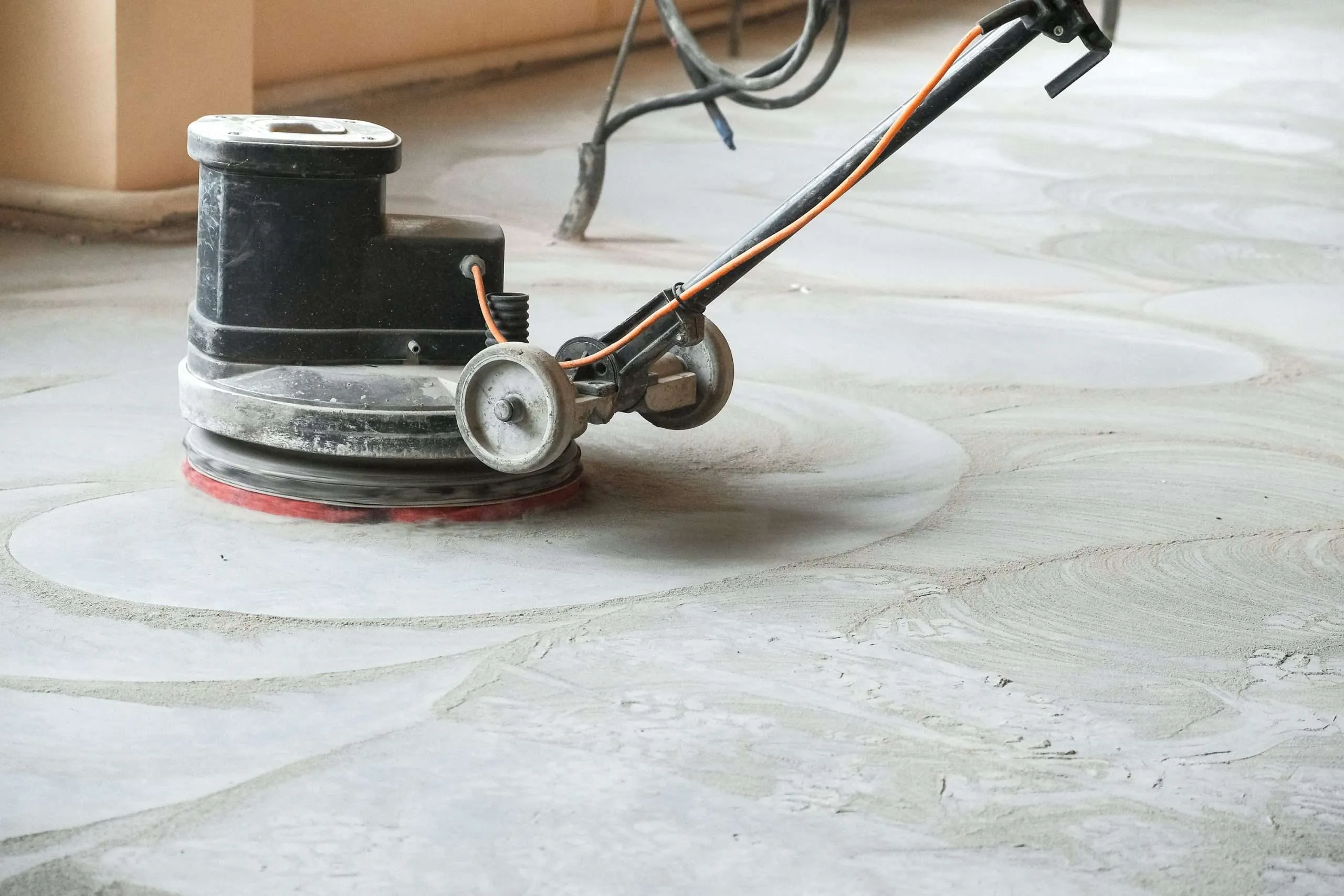 Diamond grinding machine preparing concrete surface for flooring and coating systems, ensuring smooth, even surface profile and removing contaminants.